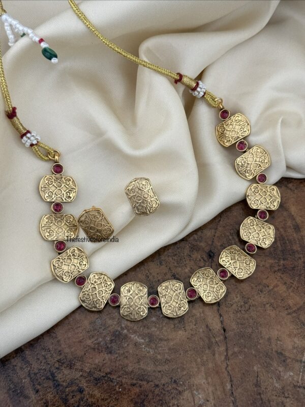 Carvings and red stone set