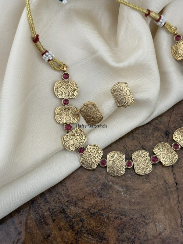 Carvings and red stone set