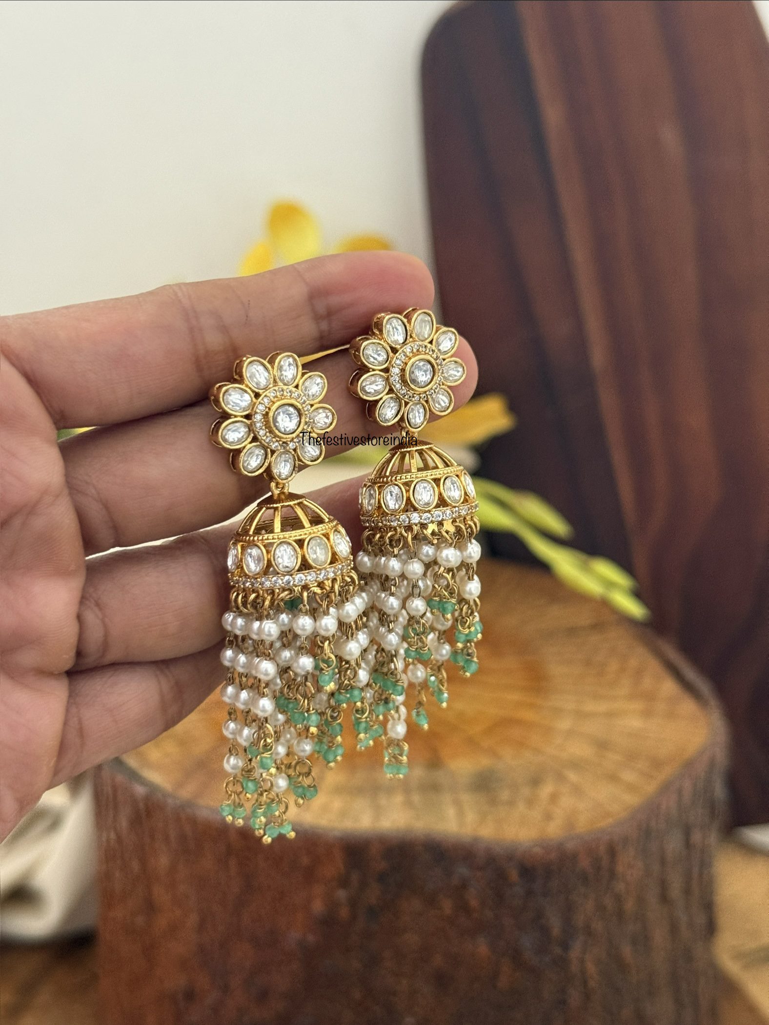 Floral jhumka with green asymmetric drop beads